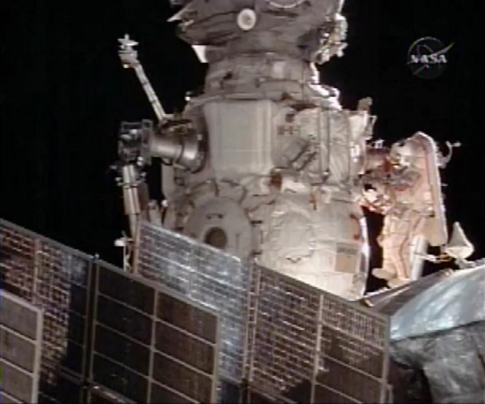 In this image from NASA TV the Commander Mike Fincke, middle right, is seen outside the International Space Station during a scheduled six-hour spacewalk, Monday, Dec. 22, 2008. (AP Photo/NASA TV)