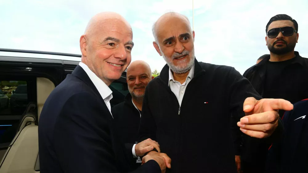 Soccer Football - International Friendly - Costa Rica v Iran - Antalya Stadium, Antalya, Turkey - March 31, 2026 First vice president of the Islamic Republic of Iran Football Federation Mehdi Mohammad Nabi shakes hands with FIFA president Gianni Infantino before the match REUTERS/Kaan Soyturk
