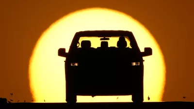 A motorist is silhouetted by the setting sun as the region hit a high temperature to tie a record for the hottest day in March in the area, Thursday, March 26, 2026, in Lenexa, Kan. (AP Photo/Charlie Riedel)