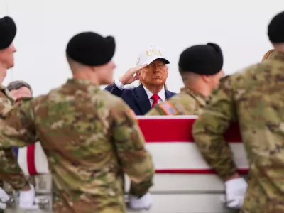 FILE - President Donald Trump salutes as an Army carry team moves a flag-draped transfer case with the remains of Sgt. Declan Coady, 20, of West Des Moines, Iowa, who was killed in a drone strike at a command center in Kuwait after the U.S. and Israel launched their military campaign against Iran, during a casualty return, March 7, 2026, at Dover Air Force Base, Del. (AP Photo/Julia Demaree Nikhinson, File)