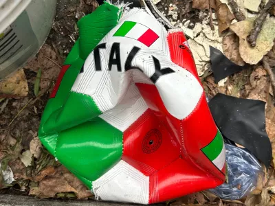 A broken soccer ball is pictured on a street in Rome, Wednesday, April 1, 2026. (AP Photo/Gregorio Borgia)
