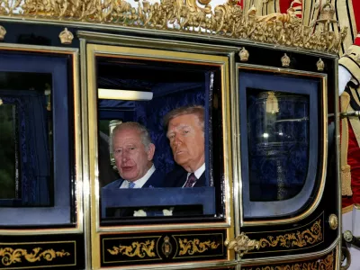 FILE PHOTO: Britain's King Charles and U.S. President Donald Trump sit in a carriage during a procession through Windsor Castle, in Windsor, Britain, September 17, 2025. REUTERS/Toby Melville/Pool   TPX IMAGES OF THE DAY/File Photo