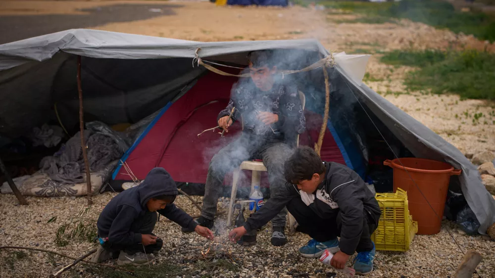 Displaced boys who fled with their family Israeli shelling in southern Lebanon make a bonfire next to their tent used as shelters in Beirut, Lebanon, Wednesday, April 1, 2026. (AP Photo/Emilio Morenatti)