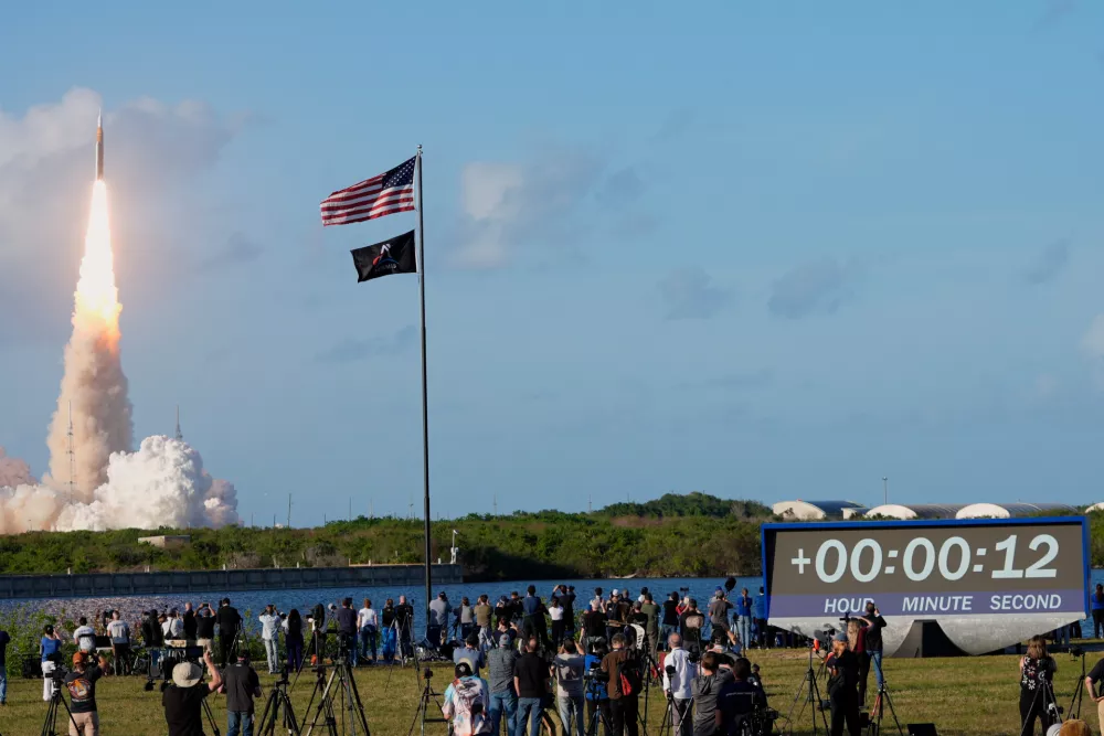 People watch as NASA's Artemis II moon rocket lifts off from the Kennedy Space Center's Launch Pad 39-B Wednesday, April 1, 2026, in Cape Canaveral, Fla. (AP Photo/John Raoux)