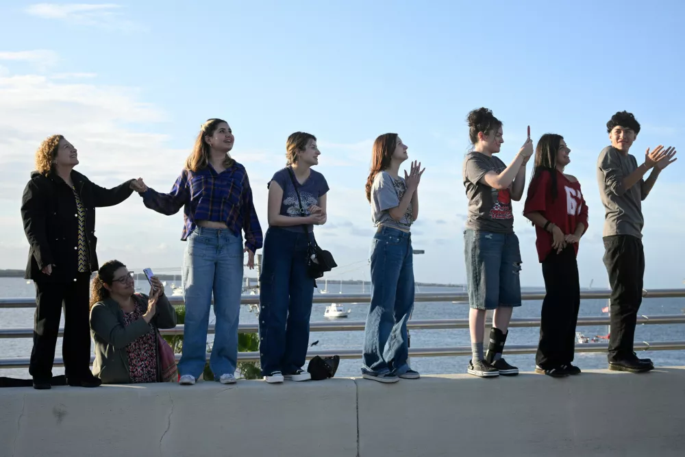Spectators view NASA's Artemis II moon rocket launch from the A. Max Brewer Bridge, Wednesday, April 1, 2026, in Titusville, Fla. (AP Photo/Phelan M. Ebenhack)