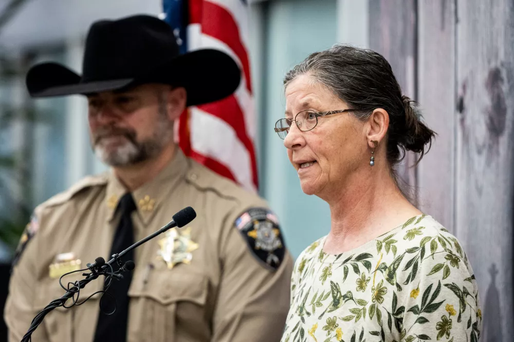 Michelle Impala, right, sister of Laura Ann Aime, speaks, joined by Utah County Sheriff Mike Smith, during a news conference announcing that definitive evidence has linked Ted Bundy to Aime's murder, at the Utah County Sheriff's Office, in Spanish Fork, Utah, Wednesday, April 1, 2026. (Isaac Hale/The Deseret News via AP)