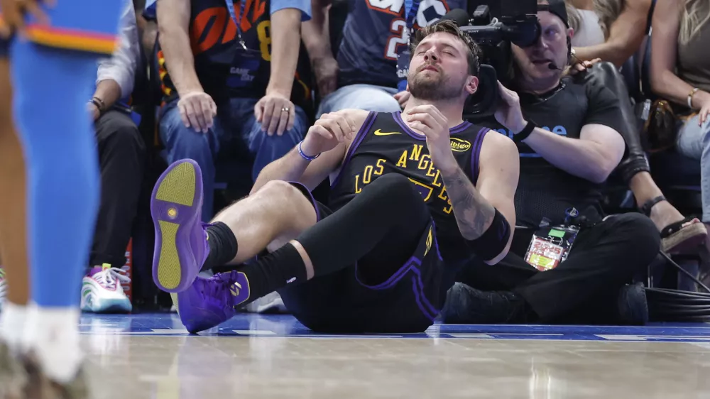 Apr 2, 2026; Oklahoma City, Oklahoma, USA; Los Angeles Lakers guard Luka Doncic (77) falls to the court during a play against the Oklahoma City Thunder during the third quarter at Paycom Center. Mandatory Credit: Alonzo Adams-Imagn Images