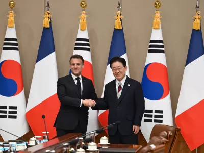 French President Emmanuel Macron shakes hands with South Korean President Lee Jae Myung during their meeting at the Blue House in Seoul, South Korea, Friday, April 3, 2026. (Jung Yeon-je/Pool Photo via AP)