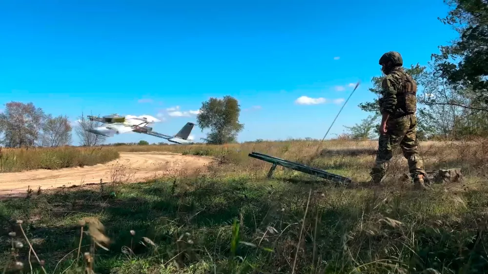 In this photo taken from video distributed by Russian Defense Ministry Press Service on Wednesday, Sept. 24, 2025, A Russian soldier launches a drone for an action in an undisclosed location in Ukraine. (Russian Defense Ministry Press Service via AP)