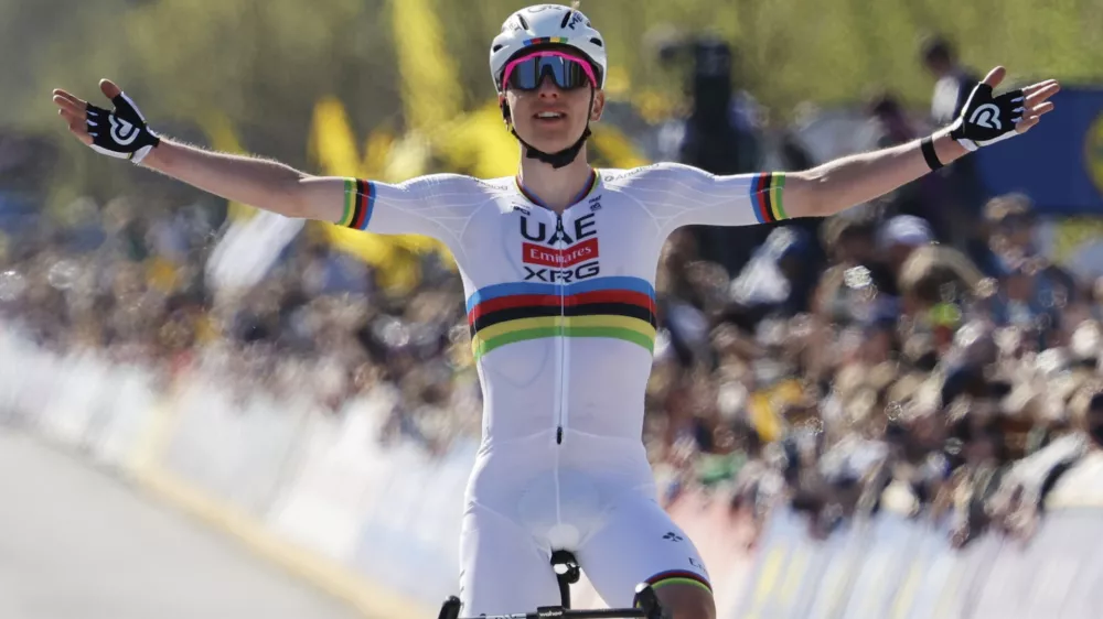 Slovenia's Tadej Pogacar, of the UAE Team Emirates XRG, crosses the finish line to win the Tour of Flanders in Oudenaarde, Belgium on Sunday, April 6, 2025. (AP Photo/Geert Vanden Wijngaert)