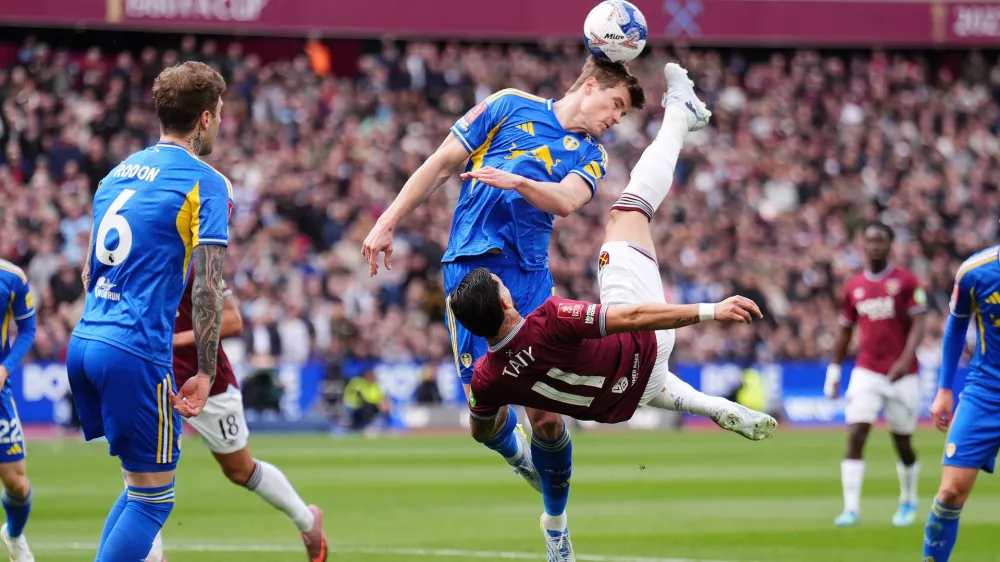 West Ham United's Taty Castellanos, front, and Leeds United's Jaka Bijol in action during the English FA Cup quarterfinal soccer match between West Ham United and Leeds United in London, Sunday April 5, 2026. (John Walton/PA via AP)