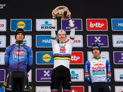 Slovenia's Tadej Pogacar celebrates after winning the Tour of Flanders cycling race, with Netherland's Mathieu Van Der Poel, left, finishing second and Belgium's Remco Evenpoel third in Oudenaarde, Belgium Sunday, April 5, 2026. (AP Photo/Geert Vanden Wijngaert)