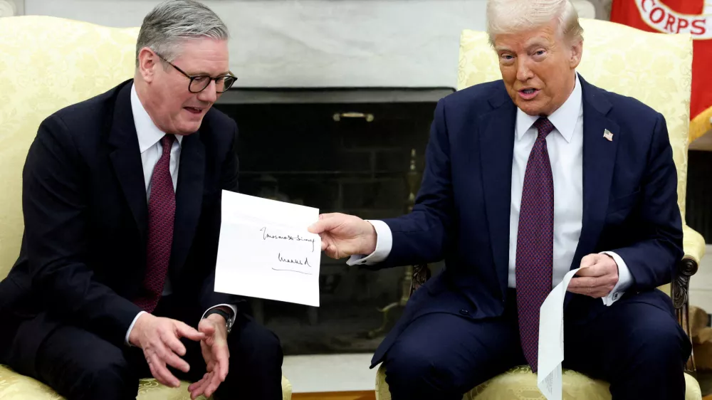 FILE PHOTO: U.S. President Donald Trump holds a letter from Britain's King Charles as he meets with British Prime Minister Keir Starmer in the Oval Office at the White House in Washington, D.C., U.S., February 27, 2025. REUTERS/Kevin Lamarque/File Photo