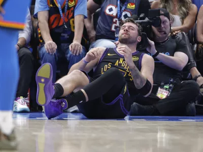 Apr 2, 2026; Oklahoma City, Oklahoma, USA; Los Angeles Lakers guard Luka Doncic (77) falls to the court during a play against the Oklahoma City Thunder during the third quarter at Paycom Center. Mandatory Credit: Alonzo Adams-Imagn Images