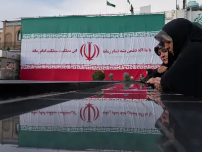Women pay their respects at a memorial to the unknown soldier and nuclear scientists killed during the 2025 Twelve-Day War, at the Emamzadeh Saleh Shrine in Tehran, Iran, Tuesday, April 7, 2026. (AP Photo/Francisco Seco)