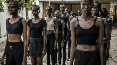 Professional models from the Juba-based modelling agency Jubalicious listen to instructions from a coach during a modelling training session at a hotel in Juba on February 19, 2026. Heels click on cracked paving stones as fantastically long-limbed men and women practice moves they hope will whisk them away from South Sudan, one of the fashion world's favourite scouting locations.Many hope to follow in the footsteps of their compatriot Awar Odhiang, who went from a refugee camp in Ethiopia to closing Chanel's Paris Fashion Week show last year. South Sudan has been mired in conflict, poverty and corruption since its independence in 2011, but the success of its models has been a ray of positivity. No less than nine of the top 50 models currently listed on Models.com are originally from the east African country.,Image: 1082447914, License: Rights-managed, Restrictions: TO GO WITH AFP STORY BY Rose TROUP BUCHANAN, Model Release: no