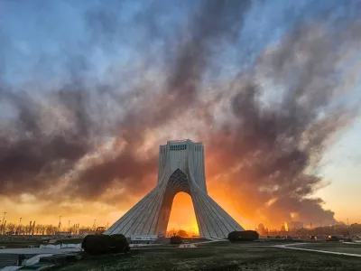 FILE - Smoke rises behind the Azadi (Freedom) monument in Tehran, Iran, on March 3, 2026, following the U.S.-Israeli military attack. (Davoud Ghahrdar/ISNA via AP, File)