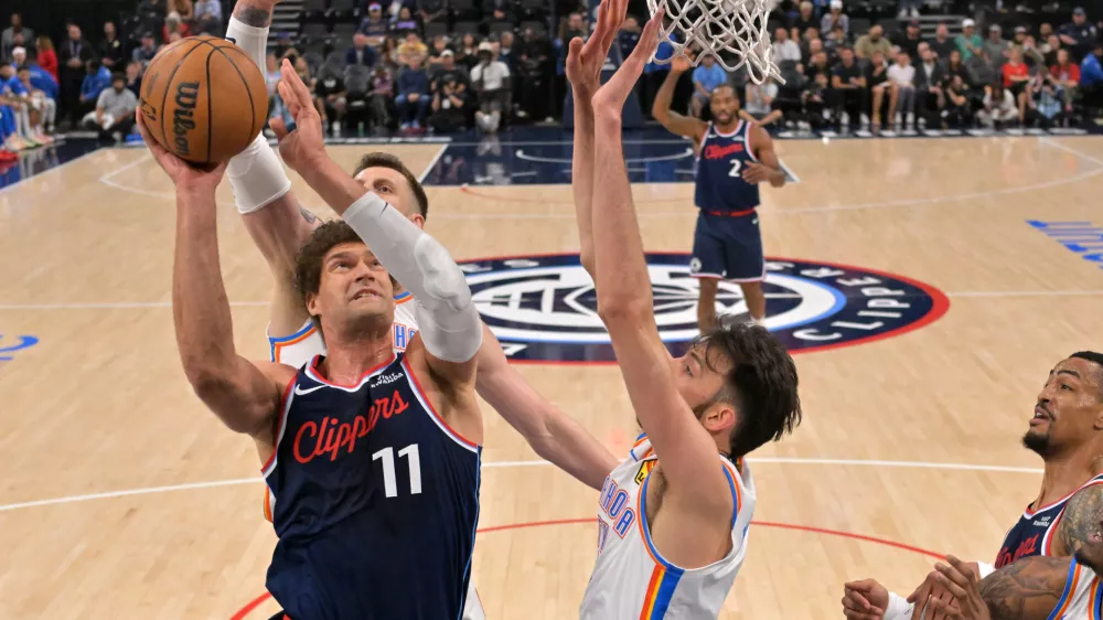 Apr 8, 2026; Inglewood, California, USA; Oklahoma City Thunder center Chet Holmgren (7), center Isaiah Hartenstein (55) defend a shot by Los Angeles Clippers center Brook Lopez (11) in the first half at Intuit Dome. Mandatory Credit: Jayne Kamin-Oncea-Imagn Images