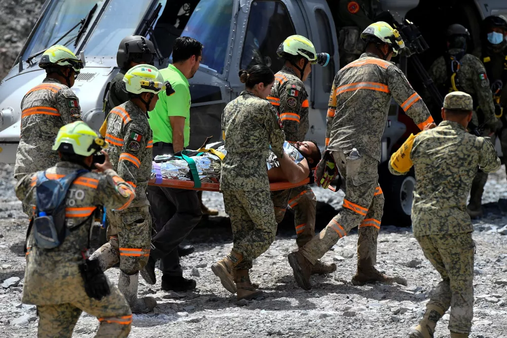 Members of rescue teams transport miner Francisco Zapata Najera, 42, on a stretcher after he was rescued during a search for four miners following a collapse at the Minerales de Sinaloa mine, in the municipality of El Rosario, Sinaloa state, Mexico, April 8, 2026. REUTERS/Stringer