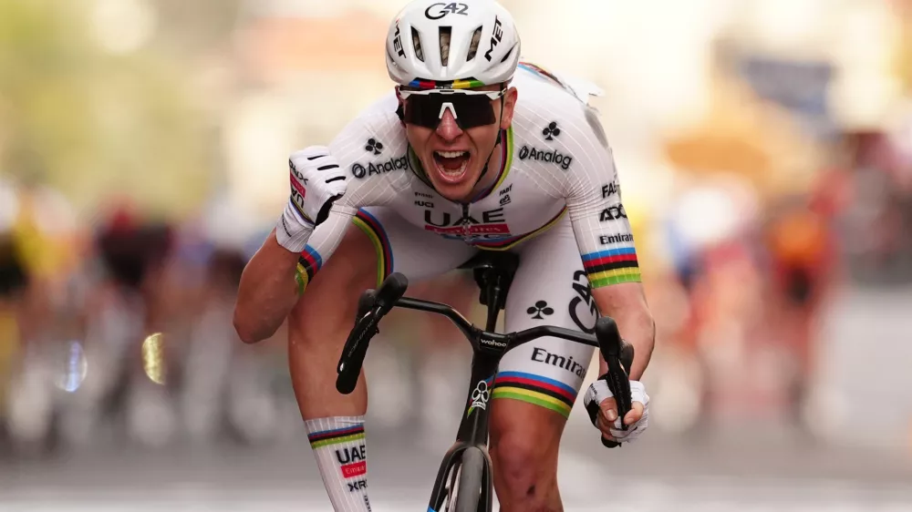Slovenia's Tadej Pogacar of UAE Team Emirates XRG celebrates after crossing the finish line ahead of Britain's Thomas Pidcock of Pinarello-Q36.5 Pro Cycling Team to win the men's elite race of the Milano-Sanremo one day cycling race (298 km) from Pavia to Sanremo, Italy, March 21, 2026. (Massimi Paolone/LaPresse via AP)