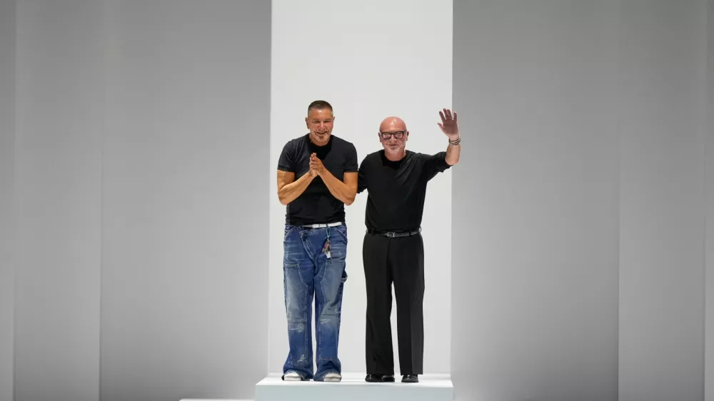 FILE - Designers Stefano Gabbana, left, Domenico Dolce accept applause after the Dolce & Gabbana Spring/Summer 2026 collection presented in Milan, Italy, Saturday, Sept. 27, 2025. (AP Photo/Luca Bruno, File)