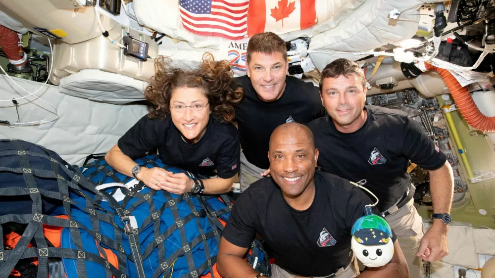 FILE PHOTO: The NASA Artemis II crew, Mission Specialist Christina Koch, Mission Specialist Jeremy Hansen, Commander Reid Wiseman, and Pilot Victor Glover, pose for a group photo inside the Orion spacecraft on their way home following a flyby of the far side of the Moon on April 6, 2026. NASA/Handout via REUTERS THIS IMAGE HAS BEEN SUPPLIED BY A THIRD PARTY. REFILE - CORRECTING DATE FROM "APRIL 6" TO "APRIL 7".  TPX IMAGES OF THE DAY/File Photo