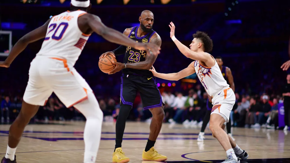 Apr 10, 2026; Los Angeles, California, USA; Los Angeles Lakers forward LeBron James (23) controls the ball against Phoenix Suns guard Koby Brea (14) during the second half at Crypto.com Arena. Mandatory Credit: Gary A. Vasquez-Imagn Images