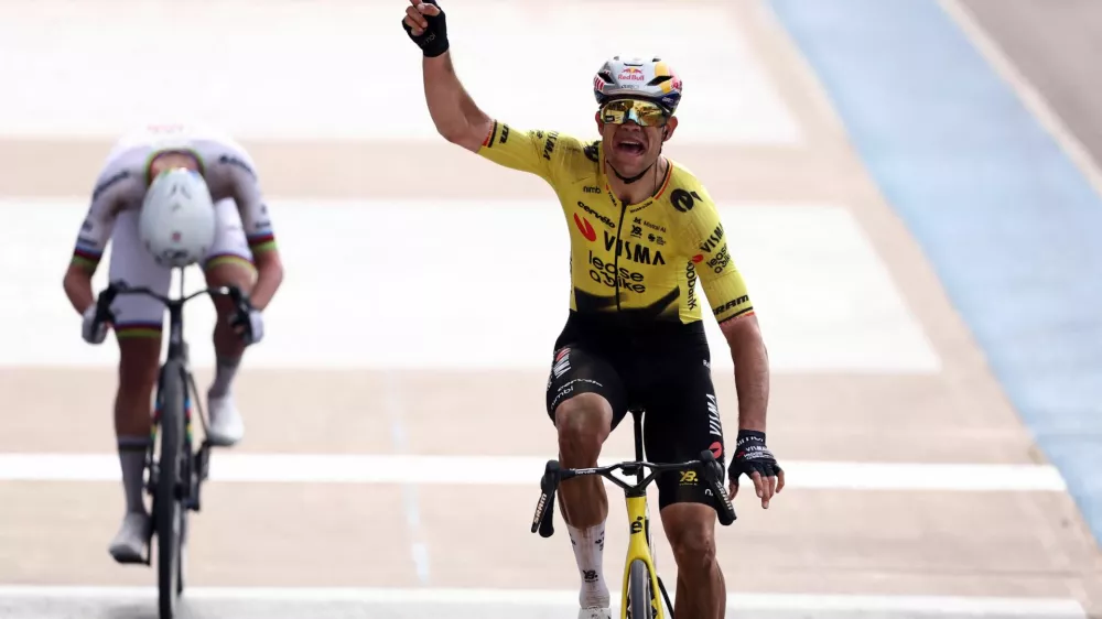 Cycling - Paris-Roubaix - Paris, France - April 12, 2026 Team Visma | Lease a Bike's Wout van Aert celebrates after crossing the finish line to win the 2026 Paris-Roubaix REUTERS/Christian Hartmann