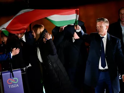 Peter Magyar, leader of the opposition Tisza party, holds a national flag following the partial results of the parliamentary election, in Budapest, Hungary, April 12, 2026. REUTERS/Marton Monus