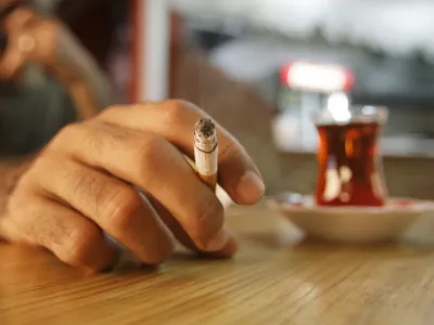 A Turkish man smokes a cigarette at a teahouse in Istanbul, Turkey, Friday, July 17, 2009, two days before a ban on smoking in bars, restaurants and coffeehouses. Turkey's government is setting up a 4,500-strong team to help enforce the upcoming no-smoking ban in this country of heavy smokers. On July 19, a year-old ban on indoor public smoking will be widened to include bars, restaurants, and even traditional smoky, hazy village coffeehouses.(AP Photo/Ibrahim Usta)