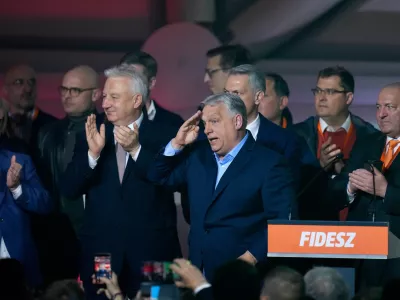 Hungary's Prime Minister Viktor Orban, center, flanked by his team reacts after a parliamentary election in Budapest, Hungary, Sunday, April 12, 2026. (AP Photo/Petr David Josek)