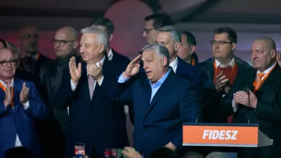 Hungary's Prime Minister Viktor Orban, center, flanked by his team reacts after a parliamentary election in Budapest, Hungary, Sunday, April 12, 2026. (AP Photo/Petr David Josek)
