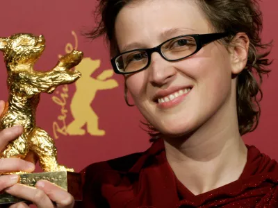 Bosnian director Jasmila Zbanic poses with her Golden Berlin Bear award after the awarding ceremony at the 56th Berlinale International Film Festival in Berlin on Saturday, Feb. 18, 2006. Zbanic won the award for the Best Film 'Gbravica'. (AP Photo/Arnd Wiegmann, Pool)