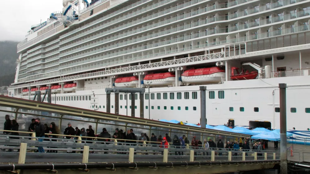 FILE - Passengers stream off the Norwegian Bliss after the vessel arrived, in Juneau, Alaska, April 25, 2022. (AP Photo/Becky Bohrer, File)