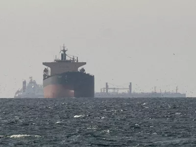 FILE PHOTO: Cargo ships in the Gulf, near the Strait of Hormuz, as seen from northern Ras al-Khaimah, near the border with Oman's Musandam governance, amid the U.S.-Israeli conflict with Iran, in United Arab Emirates, March 11, 2026. REUTERS/Stringer//File Photo