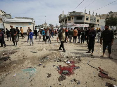 Palestinians gather to inspect the damage after an Israeli strike targeted a police vehicle in Gaza City, according to medics, in Gaza City, April 14, 2026. REUTERS/Dawoud Abu Alkas