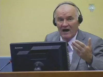 In this image taken from TV former Bosnian Serb military chief Ratko Mladic sits in the court room during his further initial appearance at the U.N.'s Yugoslav war crimes tribunal in The Hague, Netherlands, Monday, July 4, 2011. Mladic has appeared in court at the Yugoslav war crimes tribunal to enter pleas to charges including genocide. The judge refused a request by Ratko Mladic's court-appointed lawyer to postpone initial plea. (AP Photo/ICTY via APTN)