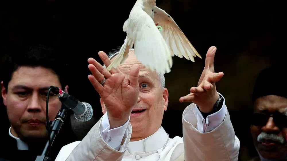 Pope Leo XIV releases a bird next to Archbishop of Bamenda Andrew Fuanya Nkea and other officials after a meeting for peace with the community of Bamenda in Saint Joseph's Cathedral in Bamenda, Cameroon, April 16, 2026. REUTERS/Guglielmo Mangiapane   TPX IMAGES OF THE DAY