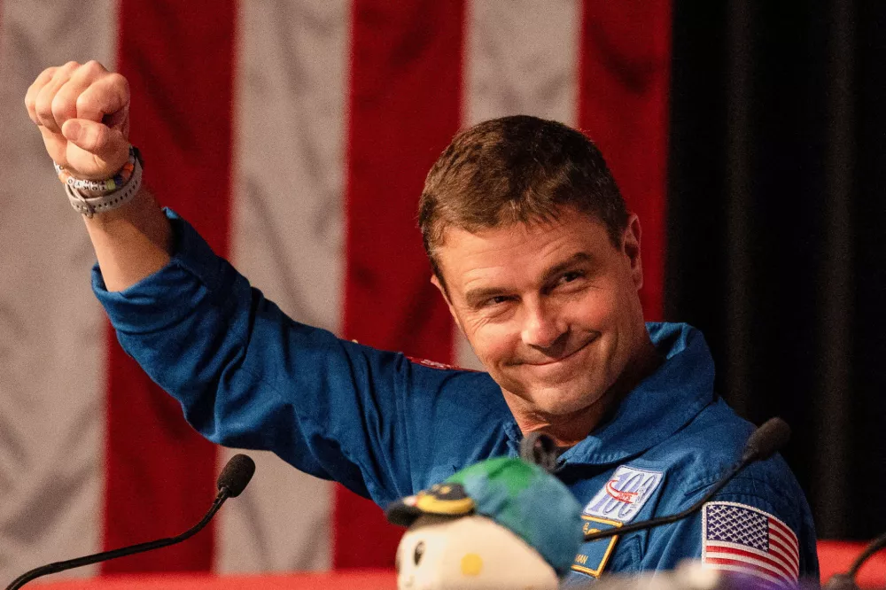 Reid Wiseman, one of the four-member crew of the Artemis II Moon mission's Orion capsule, fist pumps the air during a press conference at NASA's Johnson Space Centre in Houston, Texas, U.S., April 16, 2026. REUTERS/Lexi Parra