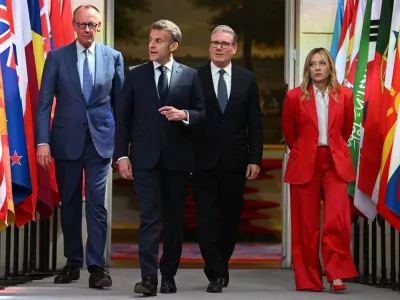 French President Emmanuel Macron, accompanied by Italian Prime Minister Giorgia Meloni, British Prime Minister Keir Starmer and German Chancellor Friedrich Merz, arrive at the Elysee Palace for a conference on the initiative for maritime navigation in the Strait of Hormuz, in Paris, France, on April 17, 2026. Jeanne Accorsini/Pool via REUTERS