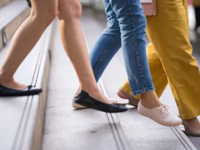 Close up of legs and shoes walking on street in the city