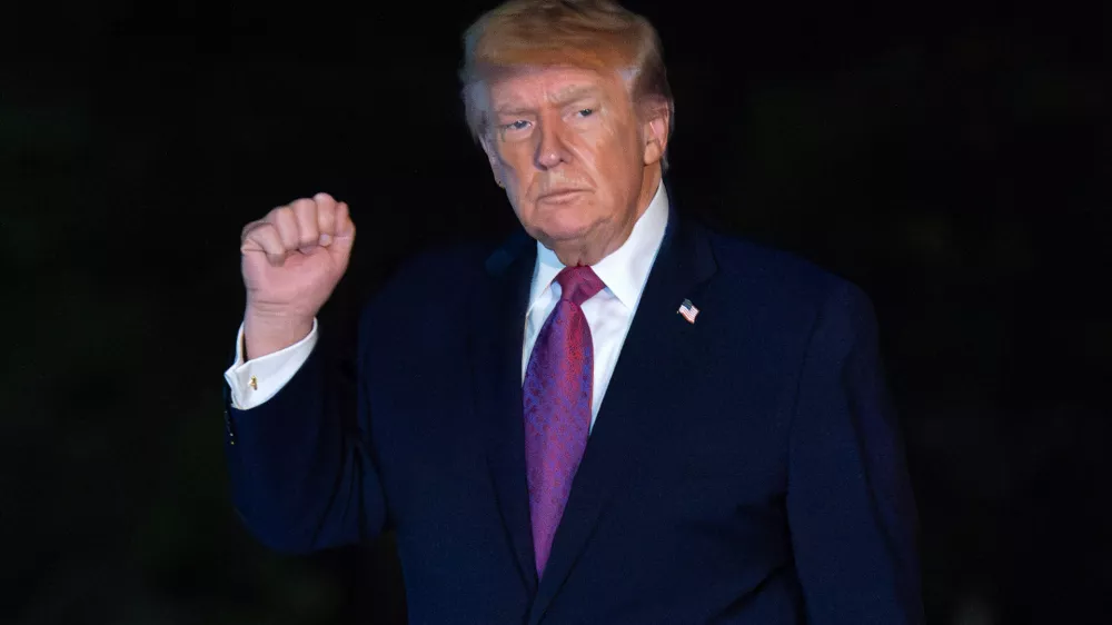 President Donald Trump waves to reporters as he walks on the South Lawn upon his arrival to the White House, Friday, April 17, 2026, in Washington. (AP Photo/Jose Luis Magana)