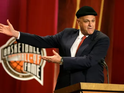 FILE - Inductee Oscar Schmidt, of Brazil, speaks during the enshrinement ceremony for this year's class of the Basketball Hall of Fame, at Symphony Hall in Springfield, Mass., Sept. 8, 2013. Schmidt, whom his Brazil compatriots know as the "Holy Hand," died. Friday, April 17, 2026. He was 68. (AP Photo/Steven Senne, File)