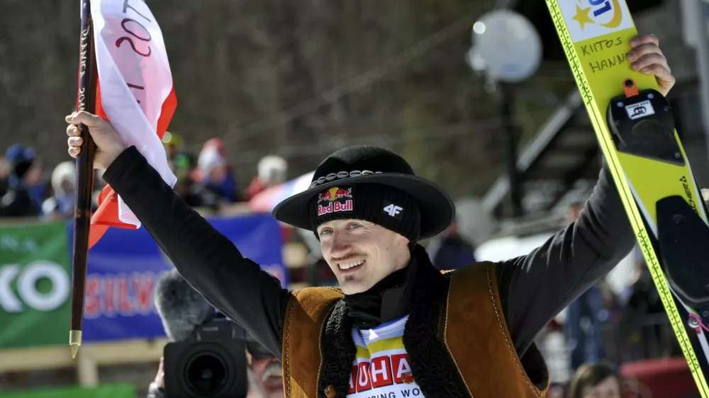 Adam Malysz of Poland greets spectators before the awarding ceremony for the overall winners of the FIS World Cup Ski Jumping 2011 in Planica, Slovenia March 20, 2011. Malysz gained third position.  REUTERS/Srdjan Zivulovic (SLOVENIA - Tags: SPORT SKI JUMPING)