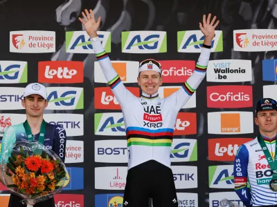 First place, Slovenia's Tadej Pogacar of the UAE Team Emirates, center, poses on the podium with second place France's Paul Seixas, left, and third place Belgium's Remco Evenepoel of the Red Bull Bora Hansgrohe team during the Belgian cycling classic and UCI World Tour race Liege Bastogne Liege, in Liege, Belgium, Sunday, April 26, 2026. (AP Photo/Geert Vanden Wijngaert)