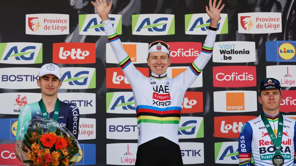 First place, Slovenia's Tadej Pogacar of the UAE Team Emirates, center, poses on the podium with second place France's Paul Seixas, left, and third place Belgium's Remco Evenepoel of the Red Bull Bora Hansgrohe team during the Belgian cycling classic and UCI World Tour race Liege Bastogne Liege, in Liege, Belgium, Sunday, April 26, 2026. (AP Photo/Geert Vanden Wijngaert)