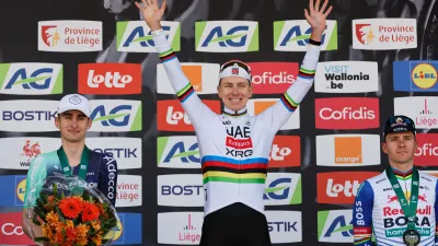 First place, Slovenia's Tadej Pogacar of the UAE Team Emirates, center, poses on the podium with second place France's Paul Seixas, left, and third place Belgium's Remco Evenepoel of the Red Bull Bora Hansgrohe team during the Belgian cycling classic and UCI World Tour race Liege Bastogne Liege, in Liege, Belgium, Sunday, April 26, 2026. (AP Photo/Geert Vanden Wijngaert)