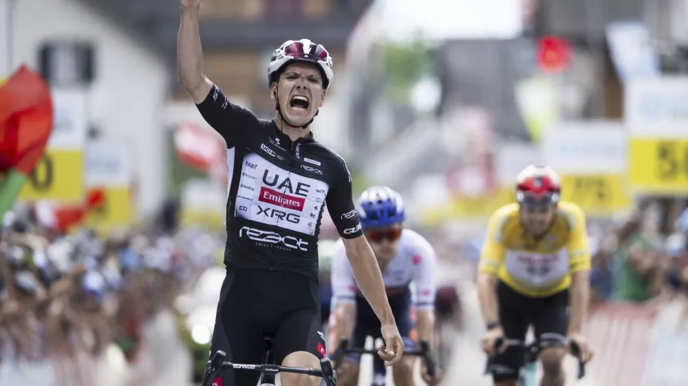 Joao Almeida of Portugal wins the seventh stage, a 207 km race from Neuhausen am Rheinfall to Emmetten, at the 88th Tour de Suisse UCI World Tour cycling race, Saturday, June 21, 2025. (Gian Ehrenzeller/Keystone via AP)