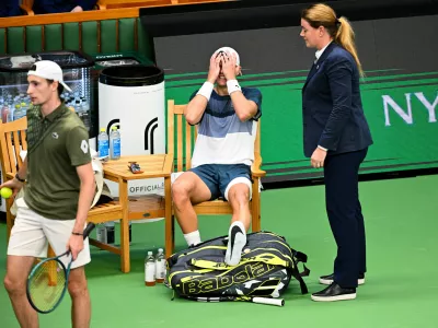 Denmark's Holger Rune reacts after injuring his foot during the men's singles semifinal tennis match against France's Ugo Humbert at the BNP Paribas Nordic Open tennis tournament in Stockholm, Sweden, Saturday, Oct. 18, 2025. (Anders Wiklund/TT via AP)