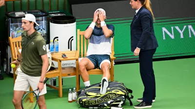 Denmark's Holger Rune reacts after injuring his foot during the men's singles semifinal tennis match against France's Ugo Humbert at the BNP Paribas Nordic Open tennis tournament in Stockholm, Sweden, Saturday, Oct. 18, 2025. (Anders Wiklund/TT via AP)